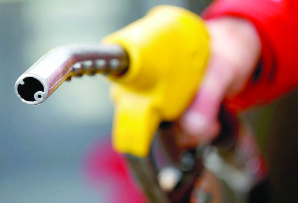 A petrol station attendant prepares to refuel a car in Rome, Italy. — Reuters