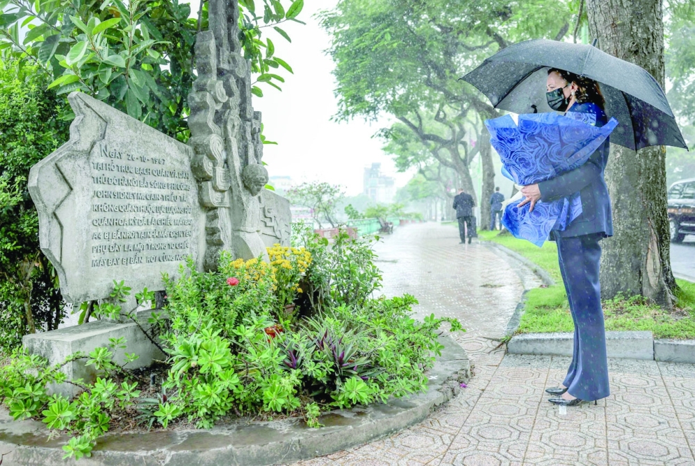US Vice President Kamala Harris lays flowers at the Senator John McCain memorial site, where his Navy aircraft was shot down by the North Vietnamese, on the three-year anniversary of his death, in Hanoi, Vietnam, on Wednesday. -- AFP