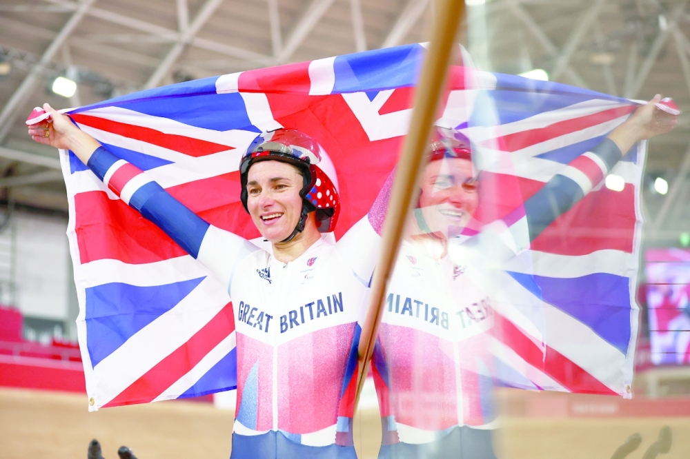Gold medallist Sarah Storey of Britain celebrates with the British flag after competing in the women's C5 3000m Individual Pursuit final in Tokyo. -- Reuters