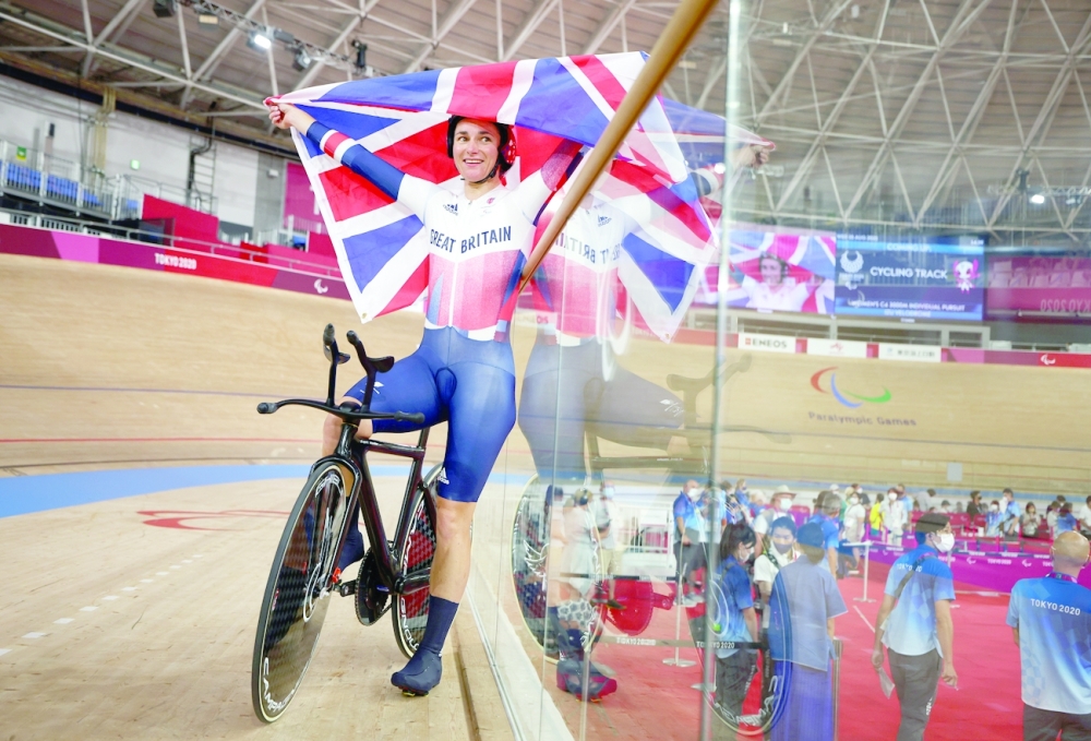 Gold medallist Sarah Storey of Britain celebrates with the British flag after competing in the women's C5 3000m Individual Pursuit final in Tokyo. -- Reuters