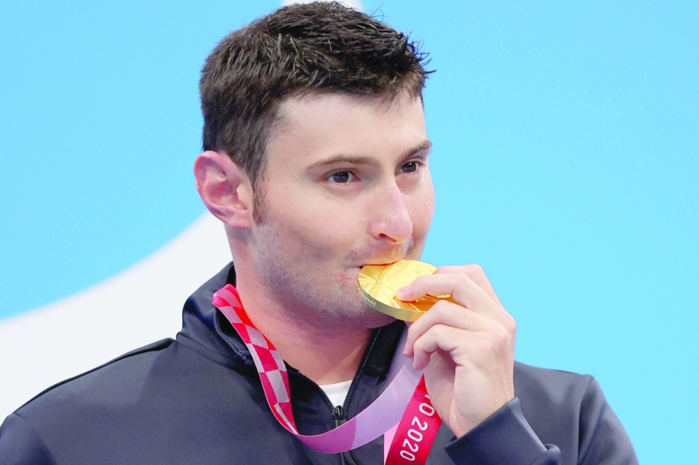 Gold medallist Francesco Bocciardo of Italy celebrates on the podium after winning men's 200m freestyle S5 swimming. -- Reuters