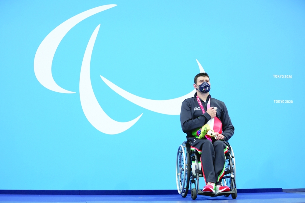 Gold medallist Francesco Bocciardo of Italy celebrates on the podium after winning men's 200m freestyle S5 swimming. -- Reuters