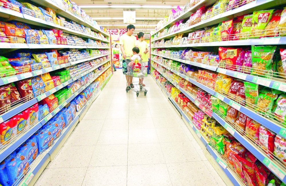 Customers walk in a supermarket in Shenyang, in northeastern China's Liaoning province. — Reuters