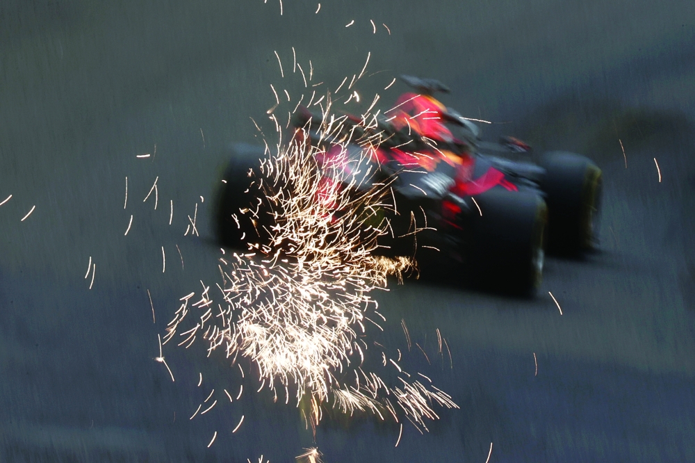 Sparks are seen from the car of Red Bull's Max Verstappen during practice. -- Reuters
