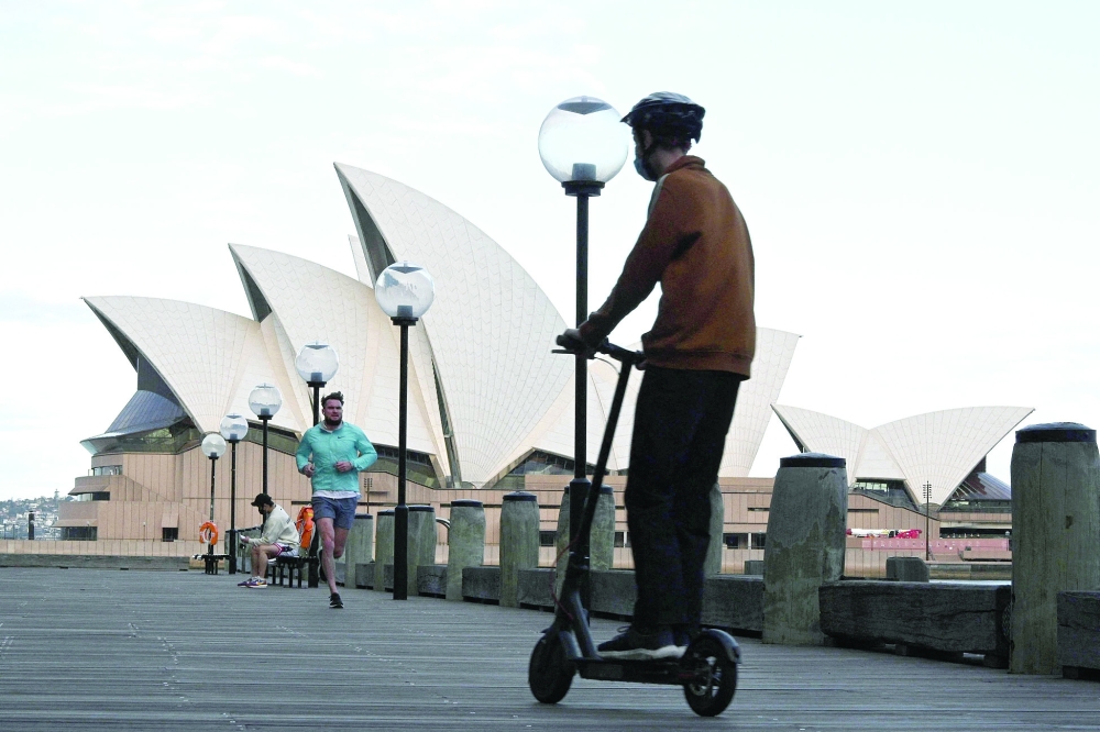 Residents exercising along the Sydney Harbour during the lockdown. -- AFP  