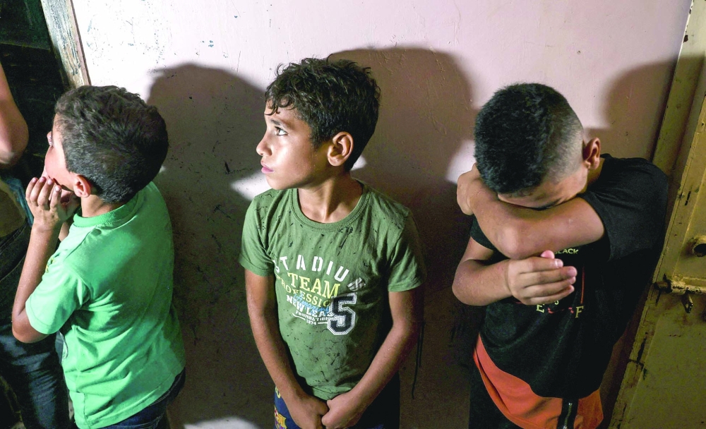 Friends and relatives of Omar Hassan Abu al Nile, who died of wounds he sustained during a protest on the Israel-Gaza border fence last week, mourn during his funeral in Gaza City, on Saturday. -- AFP