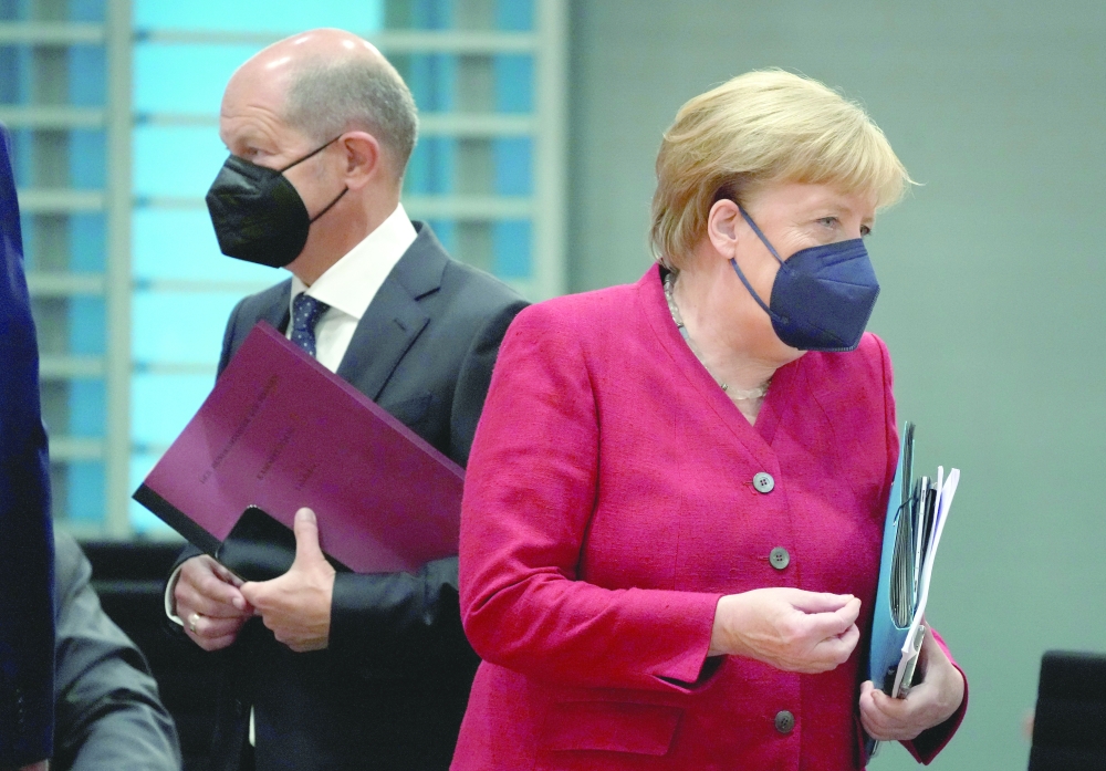 German Chancellor Angela Merkel and Finance Minister Olaf Scholz arrive for the weekly cabinet meeting at the Chancellery in Berlin. - Reuters file photo
