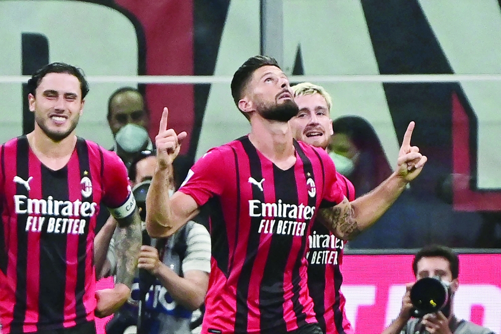 AC Milan's Olivier Giroud (R) celebrates with teammates after he scored a fourth goal for his team. -- AFP