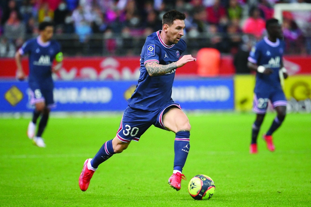Paris Saint-Germain's forward Lionel Messi runs with the ball during the French L1 match against Stade de Reims. -- AFP

