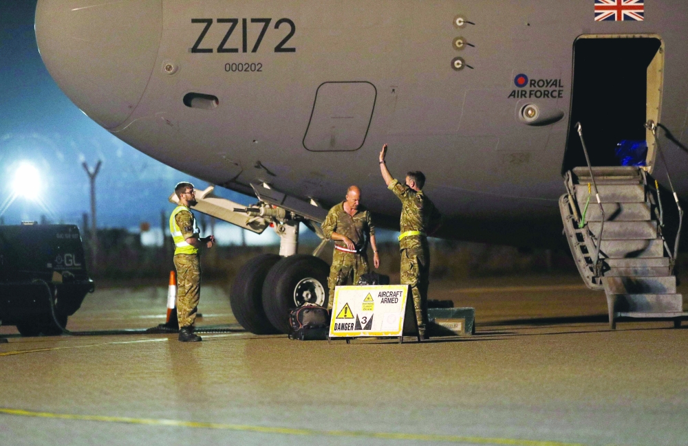 British Armed Forces personnel disembark a British Royal Air Force Boeing C-17A Globemaster III aircraft after landing at Brize Norton station after returning from deployment as part of Operation Pitting to evacuate British nationals and eligible personnel from Afghanistan. - AFP 
