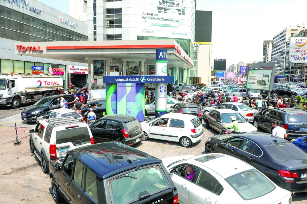 People wait in cars to get fuel at a gas station in Zalka, Lebanon. - Reuters file photo