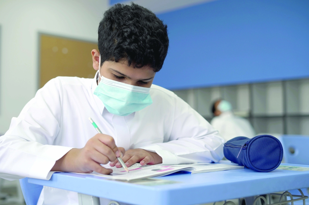 A student wearing a face mask sits in the classroom at a school in Riyadh, Saudi Arabia, on Sunday. - Reuters