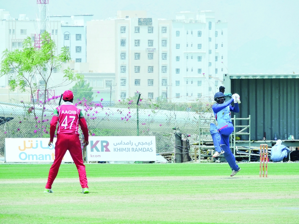 Arman Jaffer hitting a boundary against Oman
