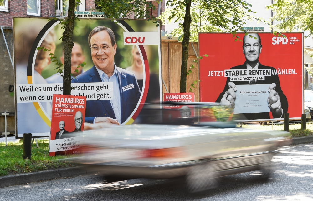 Election posters of Germany's top candidates for chancellor North Rhine-Westphalia's State Premier and CDU leader Armin Laschet and Olaf Scholz, German Minister of Finance of the SPD are seen in Hamburg. - Reuters
