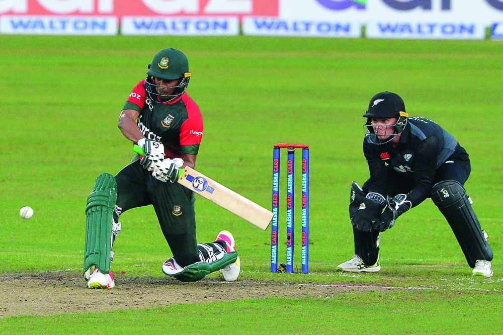 Bangladesh's Shakib Al Hasan (L) plays a shot during the first T20 against New Zealand in Dhaka. -- AFP


