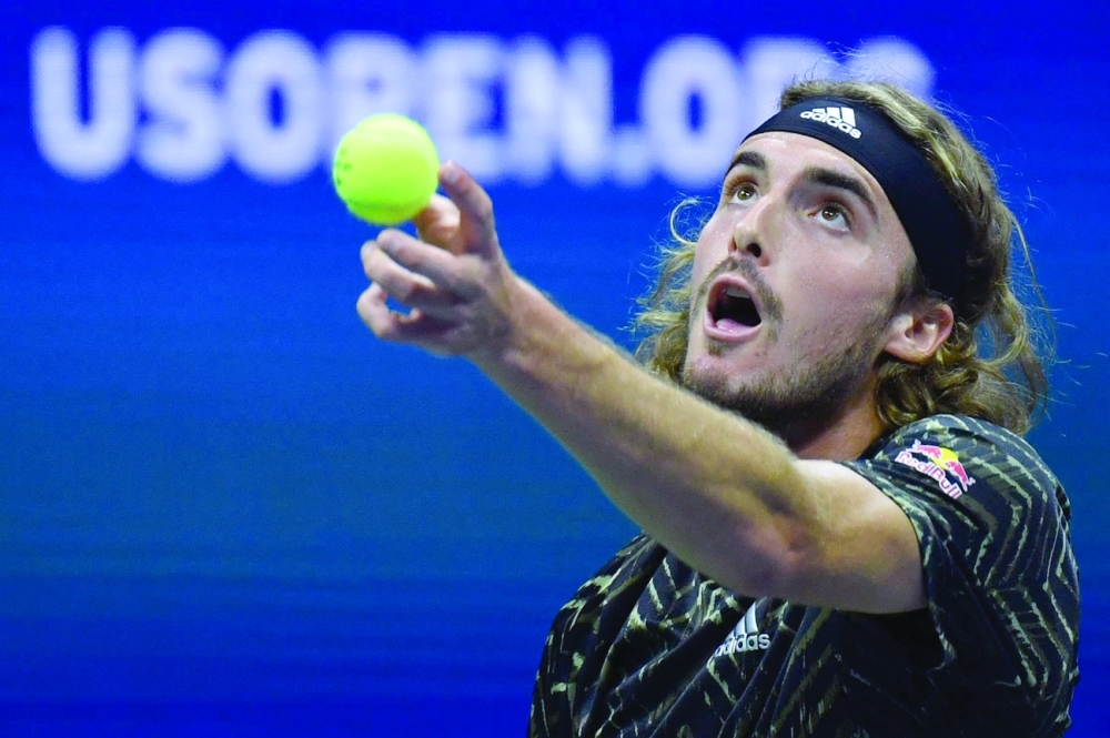 Greece's Stefanos Tsitsipas serves to France's Adrian Mannarino during their 2021 US Open Tennis tournament men's singles second round match at the USTA Billie Jean King National Tennis Center in New York, on September 1, 2021. (Photo by Ed JONES / AFP)

