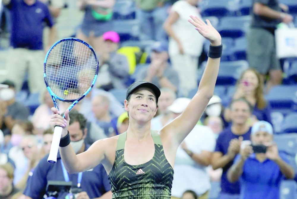 Spain's Garbine Muguruza celebrates her defeat of Germany's Andrea Petkovic during their 2021 US Open Tennis tournament women's singles second round match at the USTA Billie Jean King National Tennis Center in New York, on September 1, 2021. (Photo by Kena Betancur / AFP)

