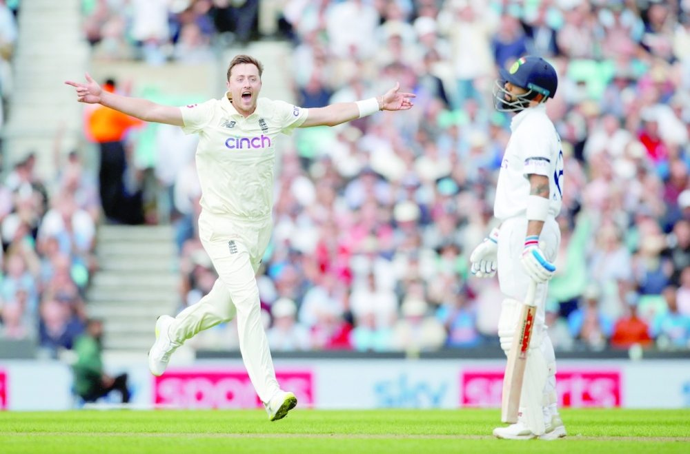 England's Ollie Robinson celebrates taking the wicket of India's Virat Kohli. -- Reuters
