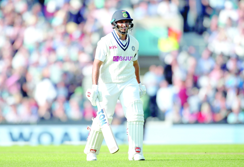 India's Shardul Thakur walks off dejected after losing his wicket to England's Chris Woakes. -- Reuters