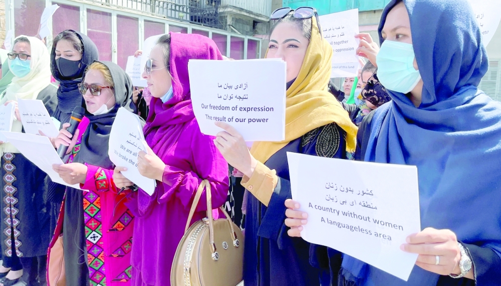 Afghan women's rights defenders and civil activists protest to call on the Taliban for the preservation of their achievements and education, in front of the presidential palace in Kabul, on Friday. -- Reuters
