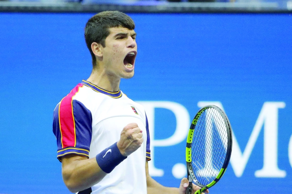 Spain's Carlos Alcaraz celebrates during his men's singles third round match against Greece's Stefanos Tsitsipas. -- AFP

