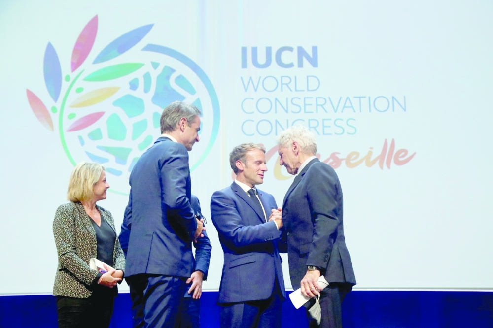 French President Emmanuel Macron greets actor Harrison Ford during the World Conservation Congress (WCC) of the International Union for Conservation of Nature (IUCN) held in Marseille on Saturday. -- Reuters