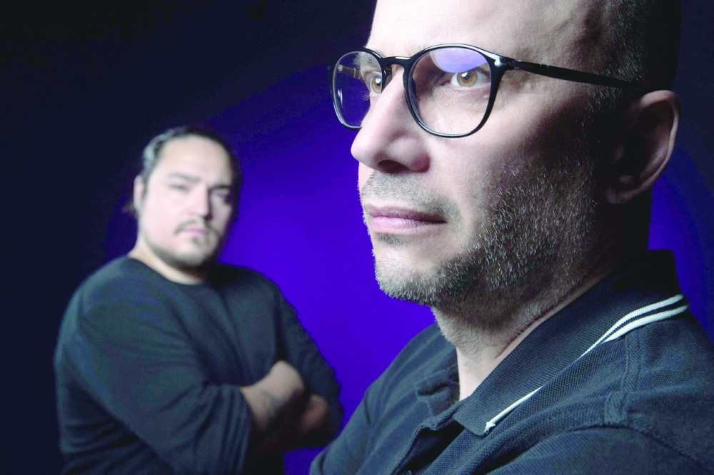 Stephane Toutlouyan (R) and David Fritz Goeppinger who were taken hostage in the November 13, 2015 Bataclan Concert Hall - pose during a studio session in Paris. AFP File