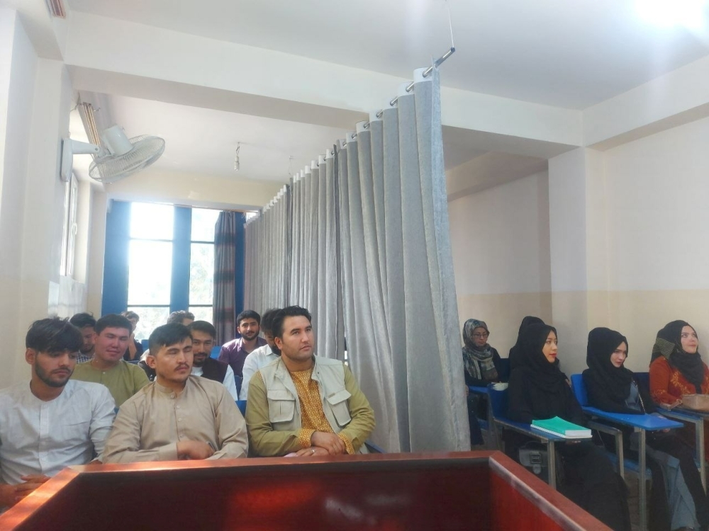 Students attend class under new classroom conditions at Avicenna University in Kabul
