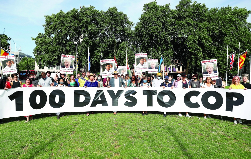 Protesters from the Climate Coalition demonstrate, with 100 hundred days to go before the start of the COP26 climate summit, in London. - Reuters File Photo
