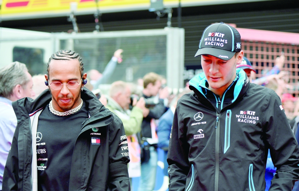Mercedes' Lewis Hamilton and Williams' George Russell before the Belgian Grand Prix race at Spa-Francorchamps. -- Reuters