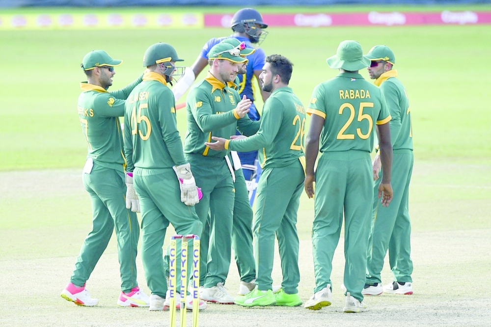 South Africa's Tabraiz Shamsi (3R) celebrates with teammates after the dismissal of Sri Lanka's Chamika Karunaratne during the third one-day international (ODI) cricket match between Sri Lanka and South Africa at the R. Premadasa Stadium in Colombo on September 7, 2021. (Photo by ISHARA S. KODIKARA / AFP)

