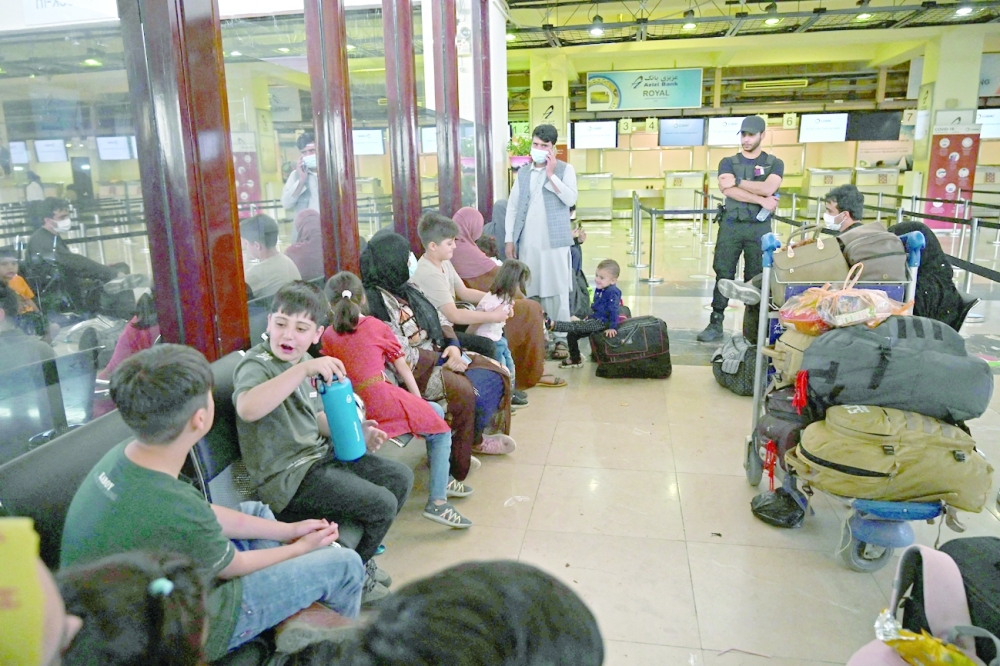 Passengers wait to board flight at the airport in Kabul. -- AFP