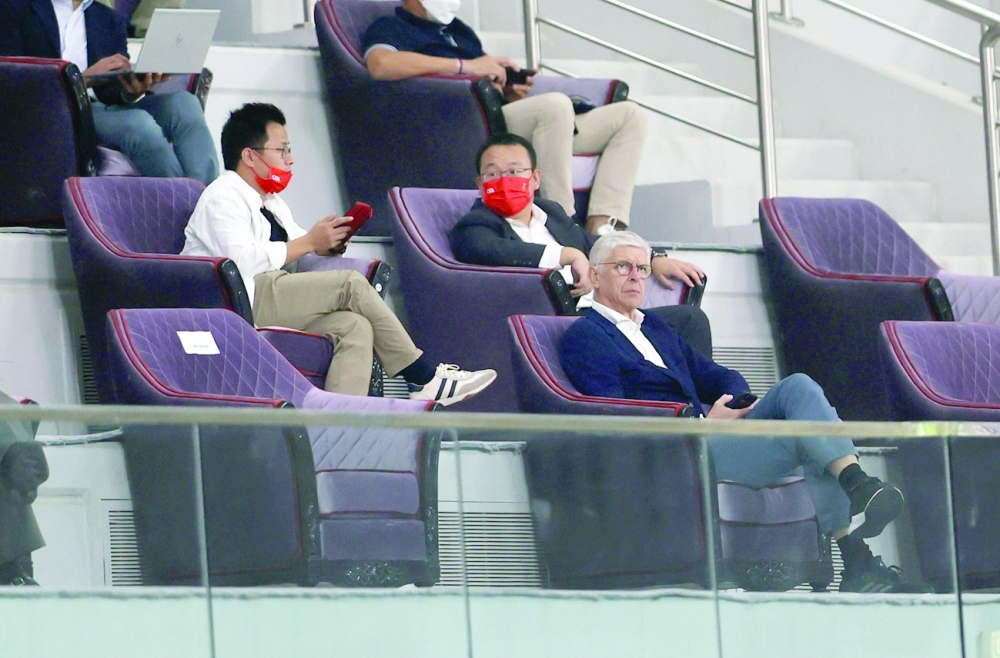 Fifa's Chief of Global Football Development Arsene Wenger in the stands during the China v Japan match in Doha. -- Reuters