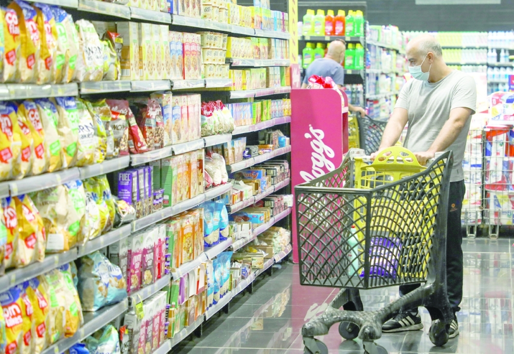 A man shops inside a supermarket in Beirut. -- Reuters
