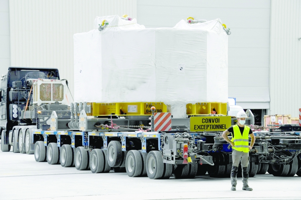 An engineer stands next to the world's most powerful magnet as it is delivered at the international nuclear fusion project Iter in Saint-Paul-les-Durance, southern France. -- AFP