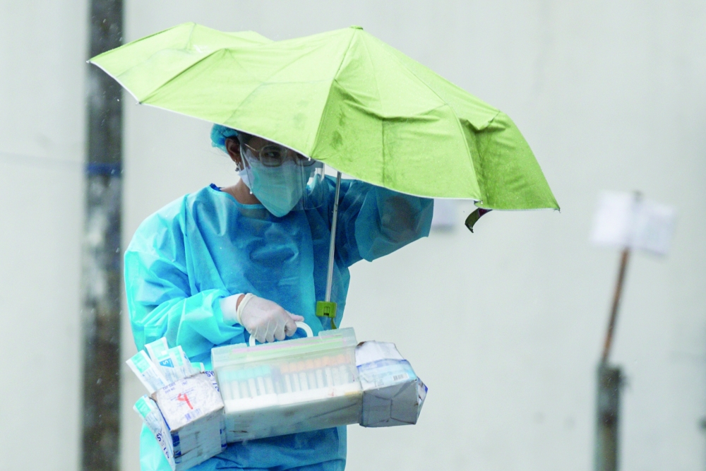 A health worker carries medical supplies at Sta Ana Hospital in Manila. -- Reuters