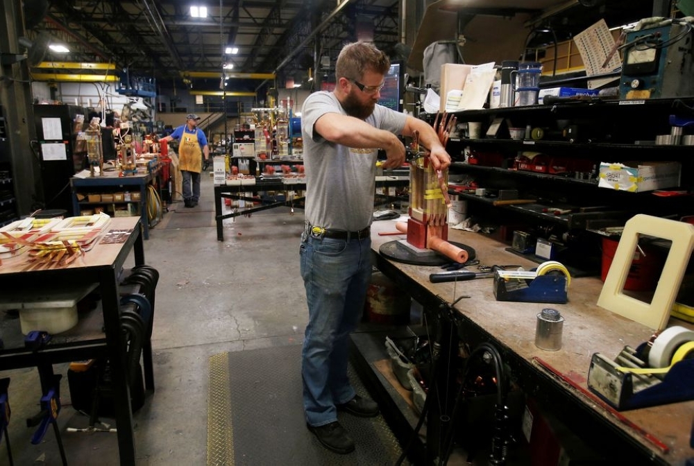 
Sub-assembly worker Joel Dykema works on the sub-assembly of a transformer in the RoMan Manufacturing plant in Grand Rapids, Michigan.- Reuters
