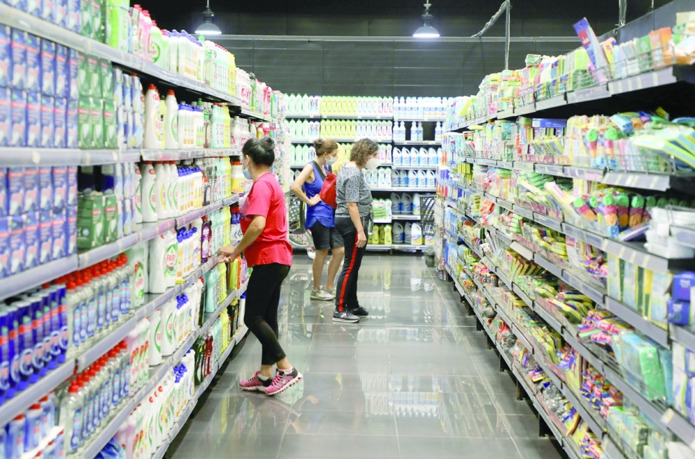 Women check for prices inside a supermarket in Beirut, Lebanon. - Reuters