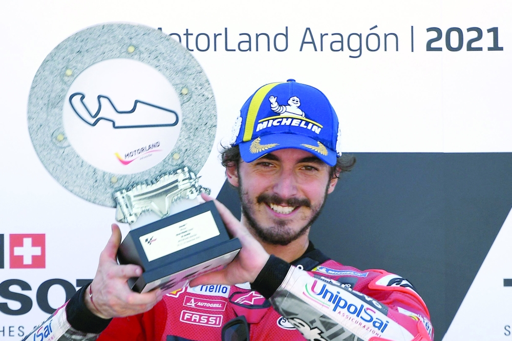 Ducati Italian rider Francesco Bagnaia celebrates on the podium after winning the Moto Grand Prix of Aragon at the Motorland circuit in Alcaniz, France. —  AFP