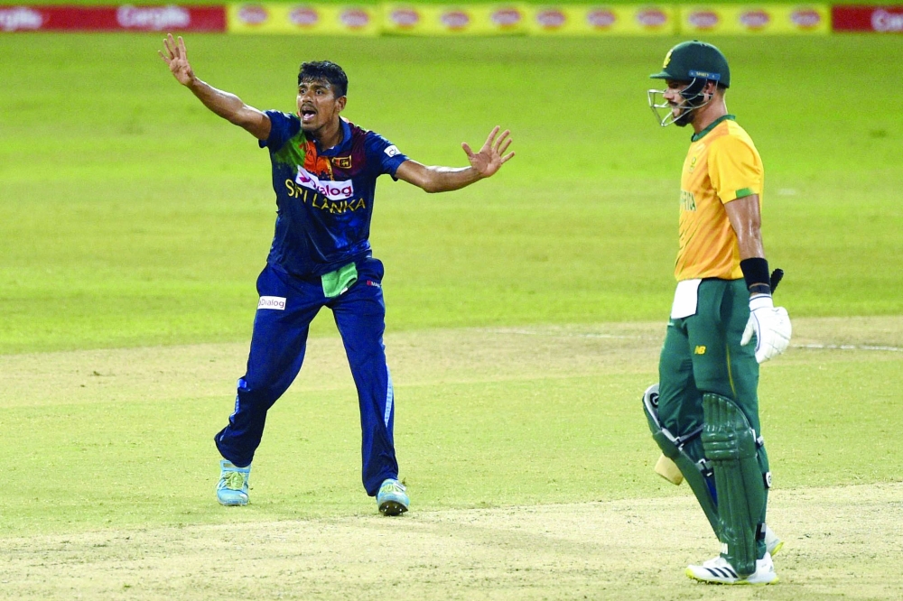 Sri Lanka’s Maheesh Theekshana (L) celebrates the dismissal of South Africa’s Heinrich Klaasen as Aiden Markram looks on during the first T20.  — AFP