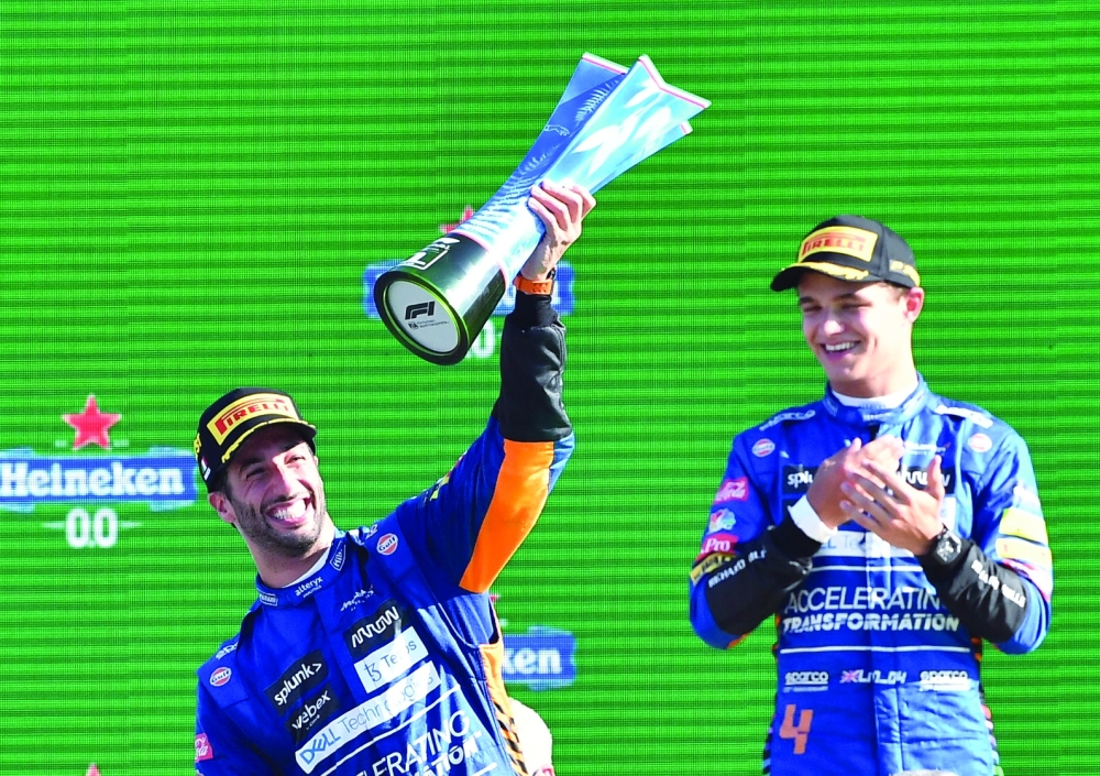 McLaren’s Daniel Ricciardo celebrates with the trophy on the podium alongside second placed McLaren’s Lando Norris ater Italian GP in Monza. — Reuters