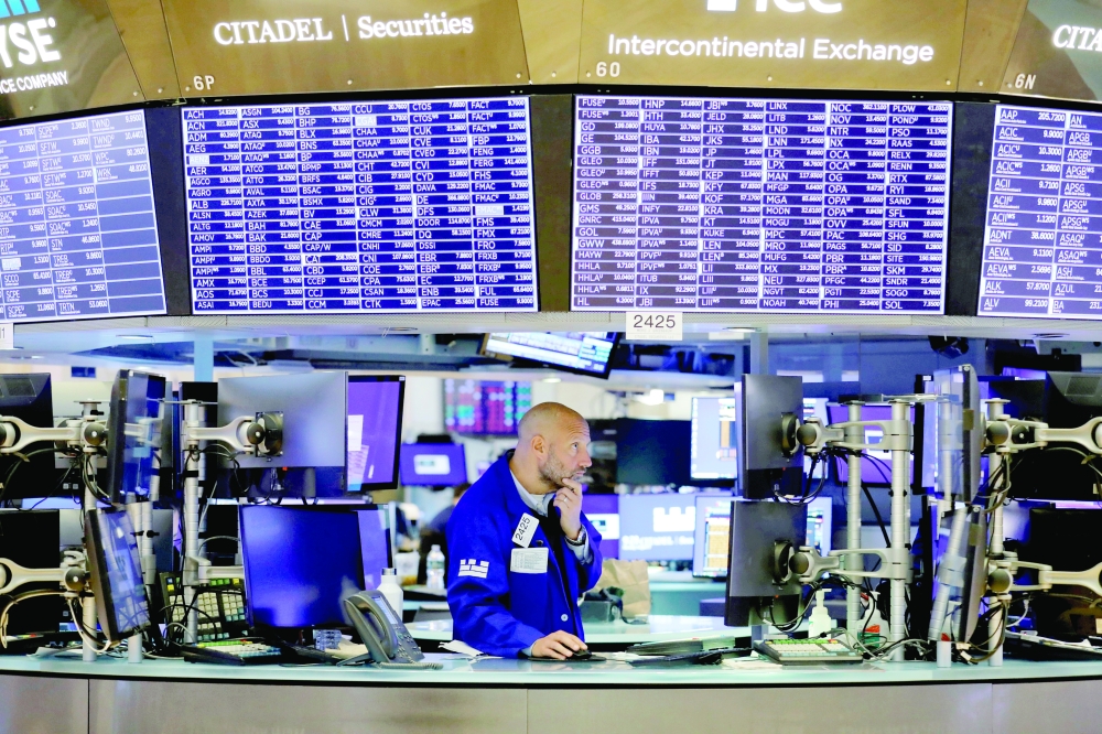 A trader works on the trading floor at the New York Stock Exchange (NYSE) in Manhattan, New York City. - Reuters File Photo 