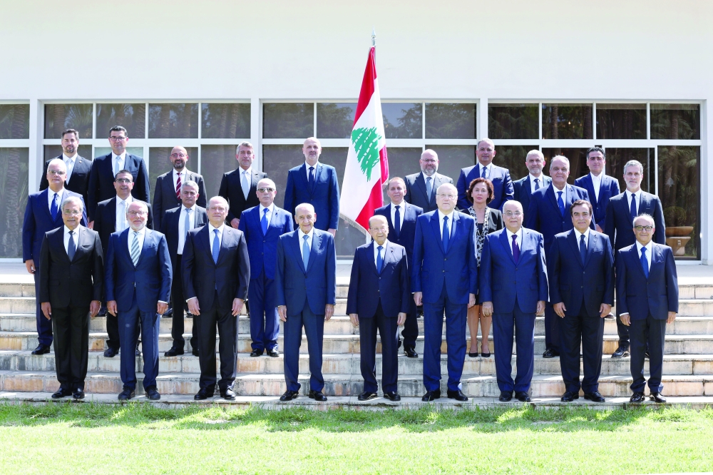 Members of the new Lebanese government pose for a group picture at the presidential palace in Baabda, Lebanon, on Monday. - Reuters