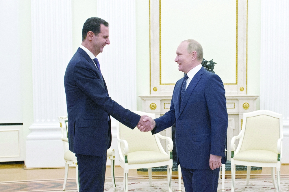 Russian President Vladimir Putin with Syrian President Bashar al Assad during a meeting at the Kremlin in Moscow on Tuesday. - Reuters