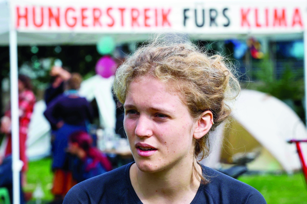 Climate activist Hannah Lubbert is seen  in a protest camp near the German parliament in Berlin. - AFP 