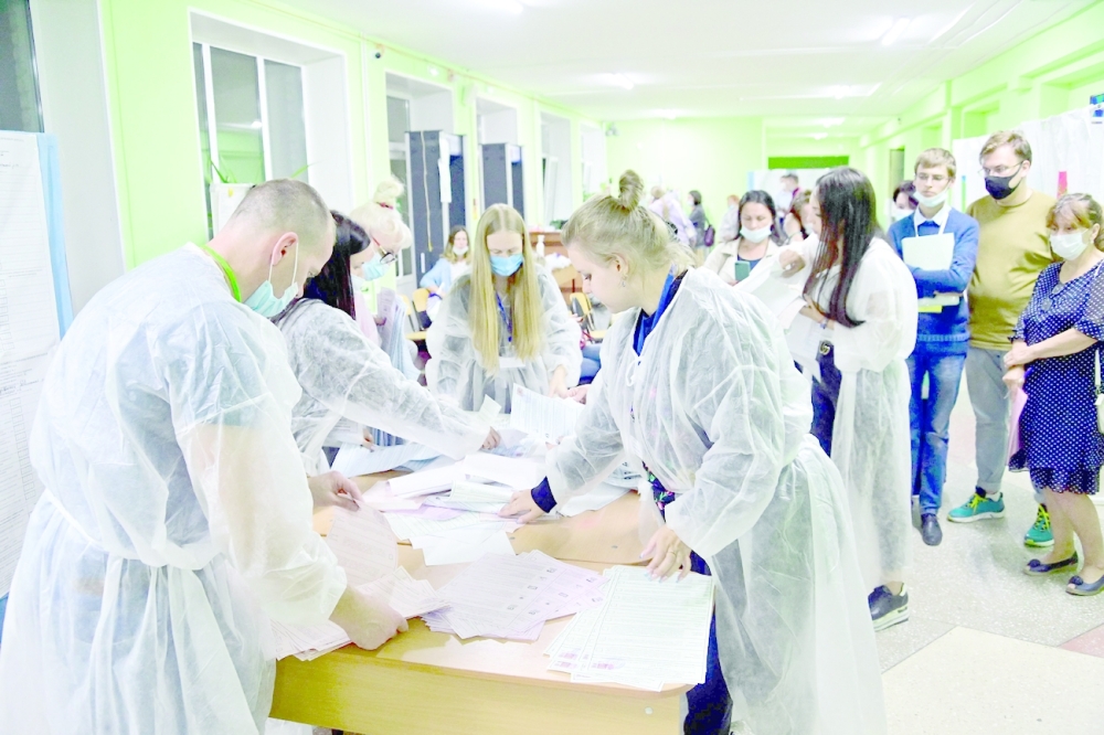 Members of a local election commission sort ballots in the far eastern city of Vladivostok on Friday. -- AFP