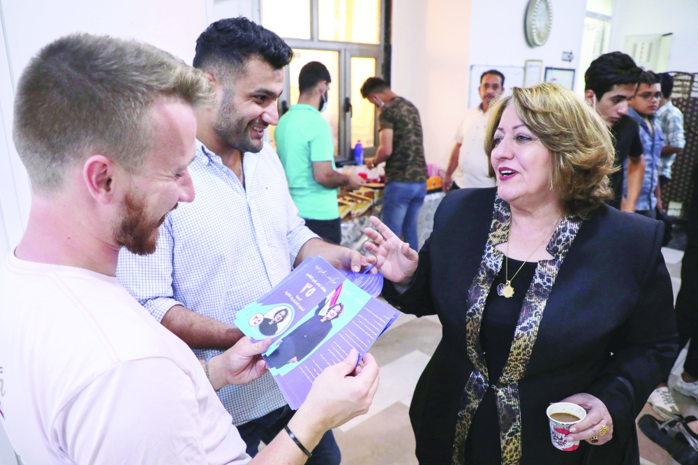 Awatef Rasheed speaks with her supporters in Basra. -- Reuters