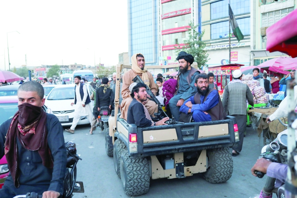 Taliban fighters roaming around the streets of Kabul. -- Reuters