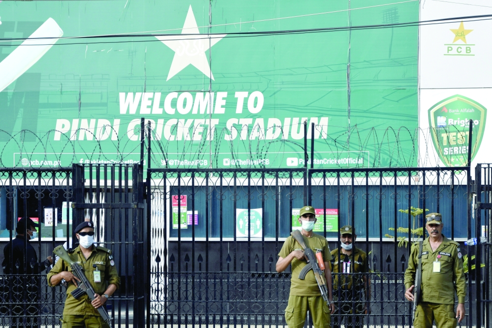 Police officers stand guard outside Rawalpindi Cricket Stadium after New Zealand cricket team pull out of a Pakistan cricket tour over security concerns. -- Reuters