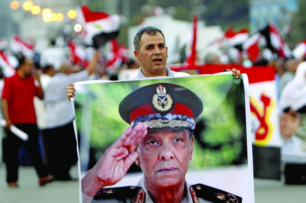 A supporter holds a poster of Field Marshal Mohamed Hussein Tantawi. - Reuters
